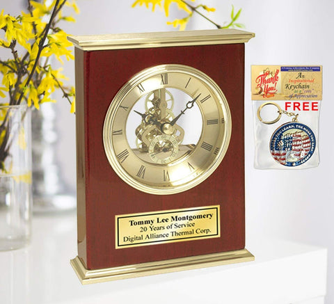 Retirement gift employee coworker service award engraved desk clock features a brass top bottom panel with glossy wood cherry display and suspended Da Vinci gear clock